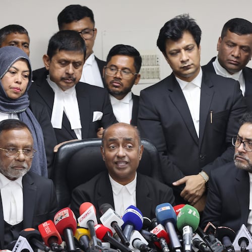 Bangladesh Attorney General Md Asaduzzaman, center sitting, and senior lawyers address a press conference after Supreme Court restored a nonpartisan caretaker government system for national elections but said it won't apply to the polls being held early next year, in Dhaka, Bangladesh, Thursday, Nov. 20, 2025. (AP Photo/Abdul Goni)