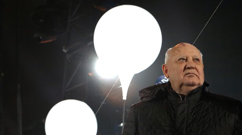 BERLIN, GERMANY - NOVEMBER 09: Former Soviet leader Mikhail Gorbachev attends celebrations for the 25th anniversary of the fall of the Berlin Wall at the Brandenburg Gate on November 9, 2014 in Berlin, Germany. The city of Berlin is commemorating the 25th anniversary of the fall of the Berlin Wall from November 7-9 with an installation of 6,800 lamps coupled with illuminated balloons along a 15km route where the Wall once ran and divided the city into capitalist West and communist East. The fall of the Wall on November 9, 1989, was among the most powerful symbols of the revolutions that swept through the communist countries of Eastern Europe and heralded the end of the Cold War. Built by the communist authorities of East Germany in 1961, the Wall prevented East Germans from fleeing west and was equipped with guard towers and deadly traps. (Photo by Adam Berry/Getty Images)