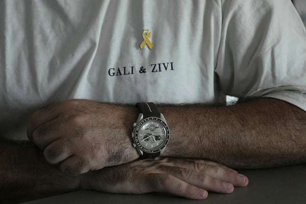Liran Berman, brother of twins Ziv and Gali Berman, who were abducted by militants on Oct. 7, 2023, wears a T-shirt with their names in Or Akiva, Israel, Wednesday, June 25, 2025. (AP Photo/Maya Alleruzzo)