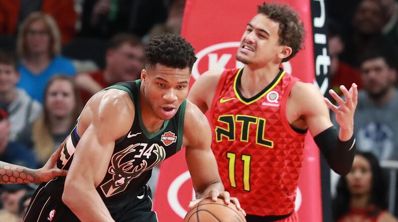 Atlanta Hawks guard Trae Young reacts as Milwaukee Bucks Giannis Antetokounmpo comes away with the defensive rebound during the first half in a NBA basketball game at State Farm Arena on Sunday, Jan. 13, 2019, in Atlanta.    Curtis Compton/ccompton@ajc.com