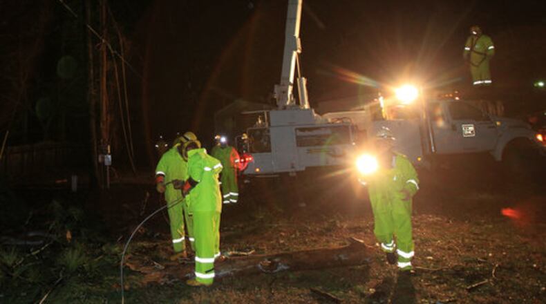 Cobb EMC crews work to restore power in the Payne Mobile Home Park in Cherokee County after trees downed power lines when storms swept through the area on Monday, Feb. 28, 2011.