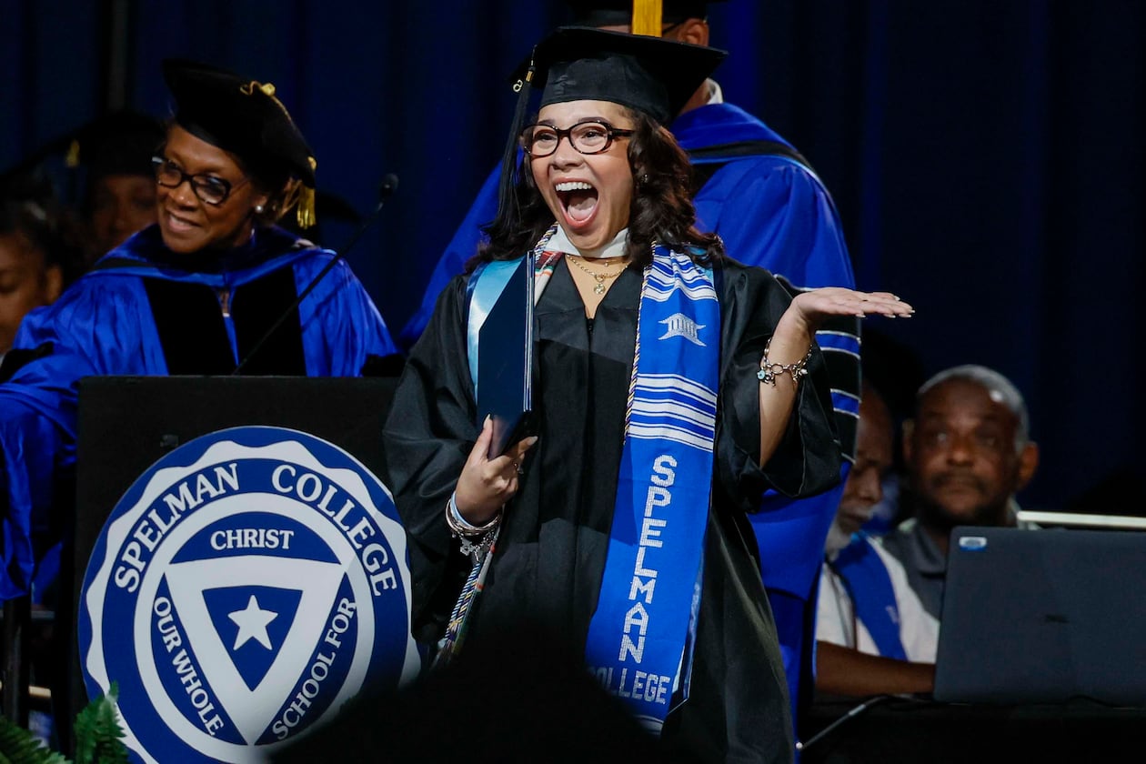 A graduate reacts after receiving her diploma during Spelman College commencement in May at the Georgia International Convention Center in College Park. Spelman's graduation rate is 76%, highest among all historically Black colleges and universities. (Miguel Martinez/AJC)