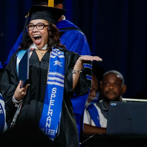 A graduate reacts after receiving her diploma during Spelman College commencement in May at the Georgia International Convention Center in College Park. Spelman's graduation rate is 76%, highest among all historically Black colleges and universities. (Miguel Martinez/AJC)