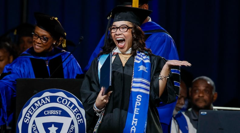 A graduate reacts after receiving her diploma during Spelman College commencement in May at the Georgia International Convention Center in College Park. Spelman's graduation rate is 76%, highest among all historically Black colleges and universities. (Miguel Martinez/AJC)