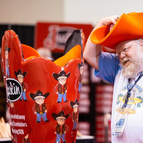 Shareholder Alex Vacca of Milwaukee poses for a photo in a foam hat in the Justin display od the Berkshire Hathaway annual meeting on Saturday, May 2, 2026, in Omaha, Neb. (AP Photo/Rebecca S. Gratz)