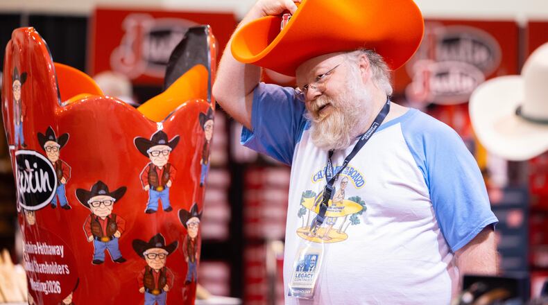 Shareholder Alex Vacca of Milwaukee poses for a photo in a foam hat in the Justin display od the Berkshire Hathaway annual meeting on Saturday, May 2, 2026, in Omaha, Neb. (AP Photo/Rebecca S. Gratz)
