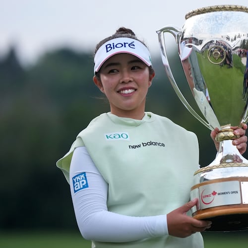 Miyu Yamashita, of Japan, celebrates with the trophy after winning the LPGA Canadian Women's Open golf tournament in Edmonton, Alberta, Sunday, Aug. 23, 2026. (Darryl Dyck/The Canadian Press via AP)
