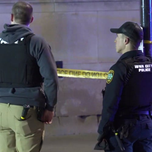 This image made from video provided by KCRG shows Iowa City police officers working the scene of a downtown shooting near the University of Iowa campus on Sunday, April 19, 2026. (KCRG via AP)