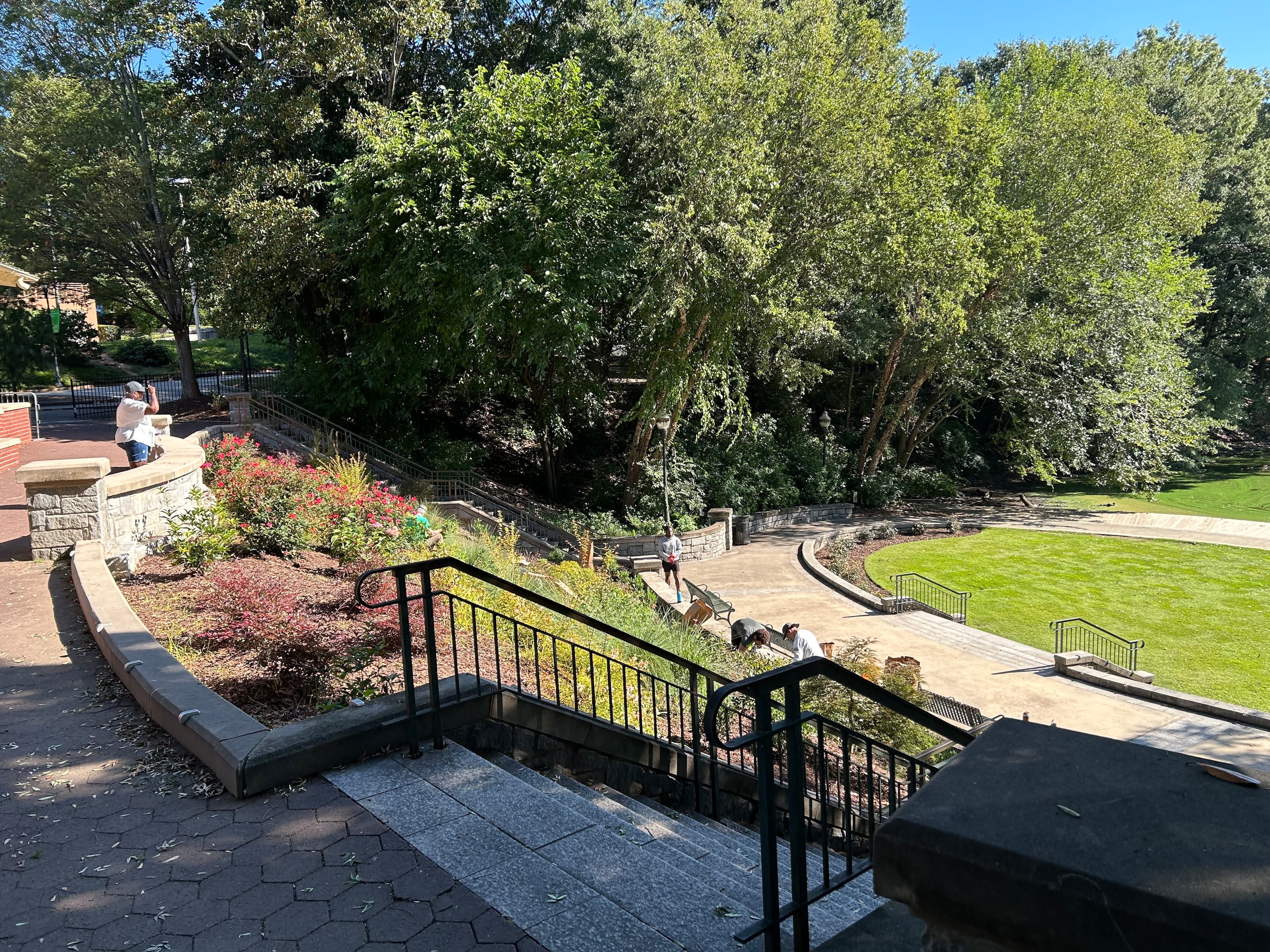 Erica Smith, left, supervises volunteers beautifying a flowerbed in Piedmont Park.