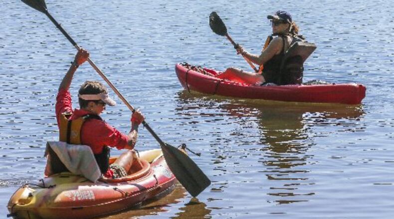 Even on the first day of fall, Carolyn Kohler (right) and Paula Johnson enjoyed the warm weather in September. JOHN SPINK / JSPINK@AJC.COM