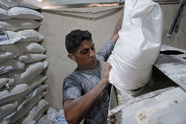 Palestinians bake bread after the World Food Program was able to bring in flour for the first time in over a month as Israel allowed some aid to enter the Gaza Strip, in Deir al-Balah, Gaza Strip, Thursday, May 22, 2025. (AP Photo/Abdel Kareem Hana)