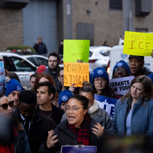 People raise signs during a news conference outside Greater New York Federal Building, Tuesday, Jan. 13, 2026, in New York. (AP Photo/Yuki Iwamura)