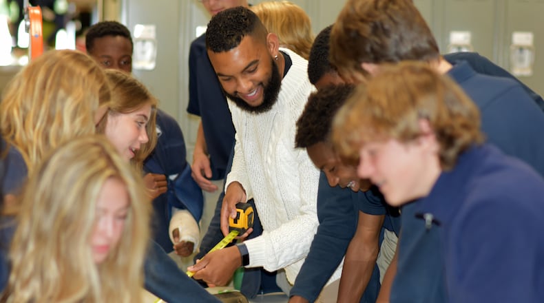 Christopher Scandrett (center), STEAM director for St. Benedict’s Episcopal School in Smyrna, has written children's STEAM books featuring kids of color.