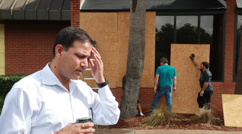 Owner C.B. Yadav stands outside his Cumberland Inn & Suites hotel as employees board up the windows in preparation for Hurricane Dorian on Monday, Sept. 2, 2019, in St. Marys. Mandatory evacuation has been issued for the area east of Interstate 95 but the hotel is staying open for employees and emergency workers.  Curtis Compton/ccompton@ajc.com