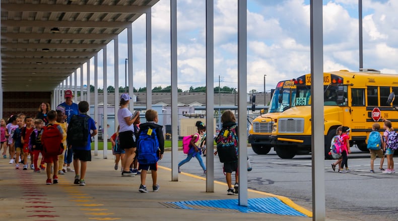 Bus riders at Liberty Elementary School in Canton finish their school day and start their ride home in Cherokee County on Thursday, Sept 2, 2021.  Substitute teachers have become even more difficult to find since the pandemic as the need grows and students are back in class. Cherokee has begun assigning central office workers to classrooms to staff positions when substitutes can't be found. (Jenni Girtman for The Atlanta Journal-Constitution)