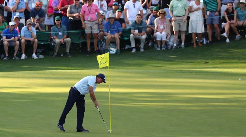 Phil Mickelson taps in a birdie put on 16 during the first round of the Masters Tournament Thursday, April 11, 2019, at Augusta National Golf Club in Augusta. Curtis Compton / ccompton@ajc.com