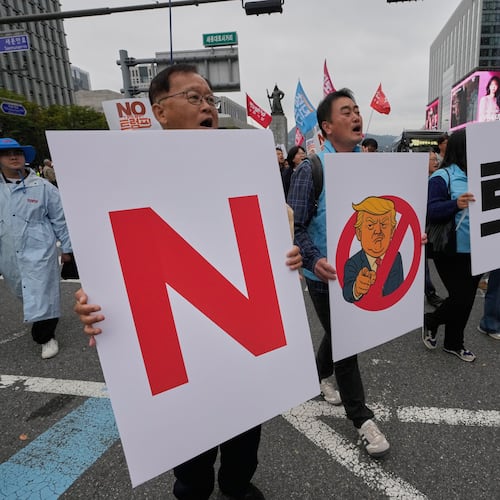 FILE - South Korean protesters march during a rally against U.S. President Donald Trump's tariffs policy on South Korea, in Seoul, South Korea, Oct. 18, 2025. The signs read "No Trump." (AP Photo/Ahn Young-joon, File)
