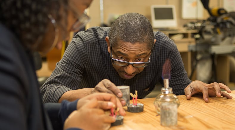 Student Leila Agbogu (left) gets help from Visual Arts teacher Andy Cunningham at Woodward Academy in Atlanta on January 30th, 2017. Woodward is the large employer AJC Top Workplace winner. (Photo by Phil Skinner)