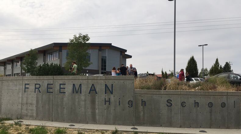 People gather outside of Freeman High School after reports of a shooting at the school in Rockford, Wash., Wednesday, Sept. 13, 2017. (KHQ via AP)