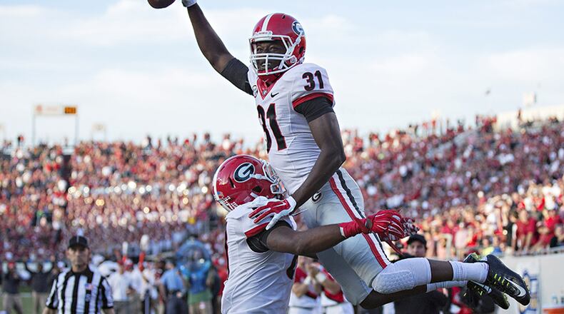 Georgia receiver Chris Conley is lifted in the air after scoring a touchdown against the Arkansas Razorbacks at War Memorial Stadium on Oct. 18, 2014, in Little Rock, Arkansas. The Bulldogs defeated the Razorbacks 45-32.