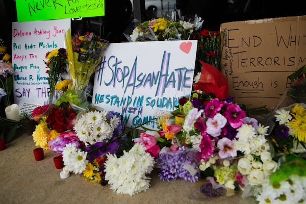 A memorial set up in from of Young's Asian Massage on Thursday, March 18, 2021, in Acworth, Georgia, to honor the lives of Delaina Ashley Yaun, Paul Andre Michels, Xiaojie Tan and Daoyou Feng, who were shot and killed in spas around Acworth, Georgia, and others who were killed in similar shootings in Atlanta, on Tuesday, March 16, 2021. Six of the eight total victims were Asian women. CHRISTINA MATACOTTA FOR THE ATLANTA JOURNAL-CONSTITUTION..
