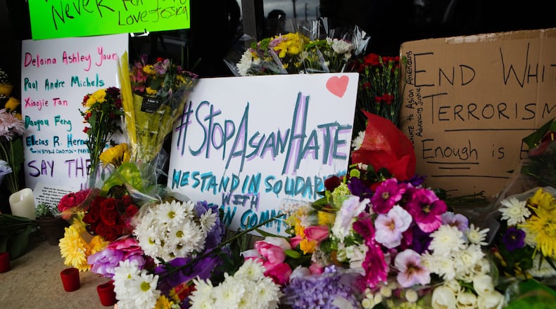 A memorial set up in from of Young's Asian Massage on Thursday, March 18, 2021, in Acworth, Georgia, to honor the lives of Delaina Ashley Yaun, Paul Andre Michels, Xiaojie Tan and Daoyou Feng, who were shot and killed in spas around Acworth, Georgia, and others who were killed in similar shootings in Atlanta, on Tuesday, March 16, 2021. Six of the eight total victims were Asian women. CHRISTINA MATACOTTA FOR THE ATLANTA JOURNAL-CONSTITUTION..