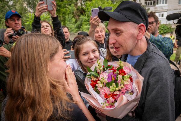 A Ukrainian soldier speaks with relatives as he returns from captivity after a POWs exchange between Russia and Ukraine, in Chernyhiv region, Ukraine, Thursday, June 19, 2025. (AP Photo/Dan Bashakov)