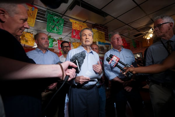 Republican nominee for governor Rick Jackson, center, speaks to reporters during a campaign event last week in Doraville. (Jason Getz/AJC)