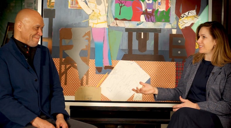 “Something Over Something Else” co-curators Robert G. O’Meally and Stephanie Heydt, in front of Romare Bearden’s “Profile/Part II. The Thirties: Artist with Painting & Model” (1981). Contributed by High Museum of Art