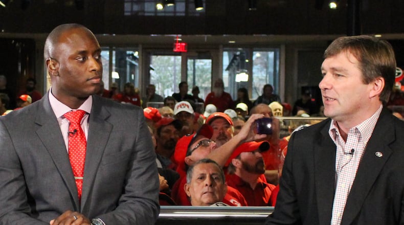 Georgia head coach Kirby Smart talks with D.J. Shockley on National Signing Day at Butts-Mehre Heritage Hall on Wednesday, Feb. 3, 2016, in Athens