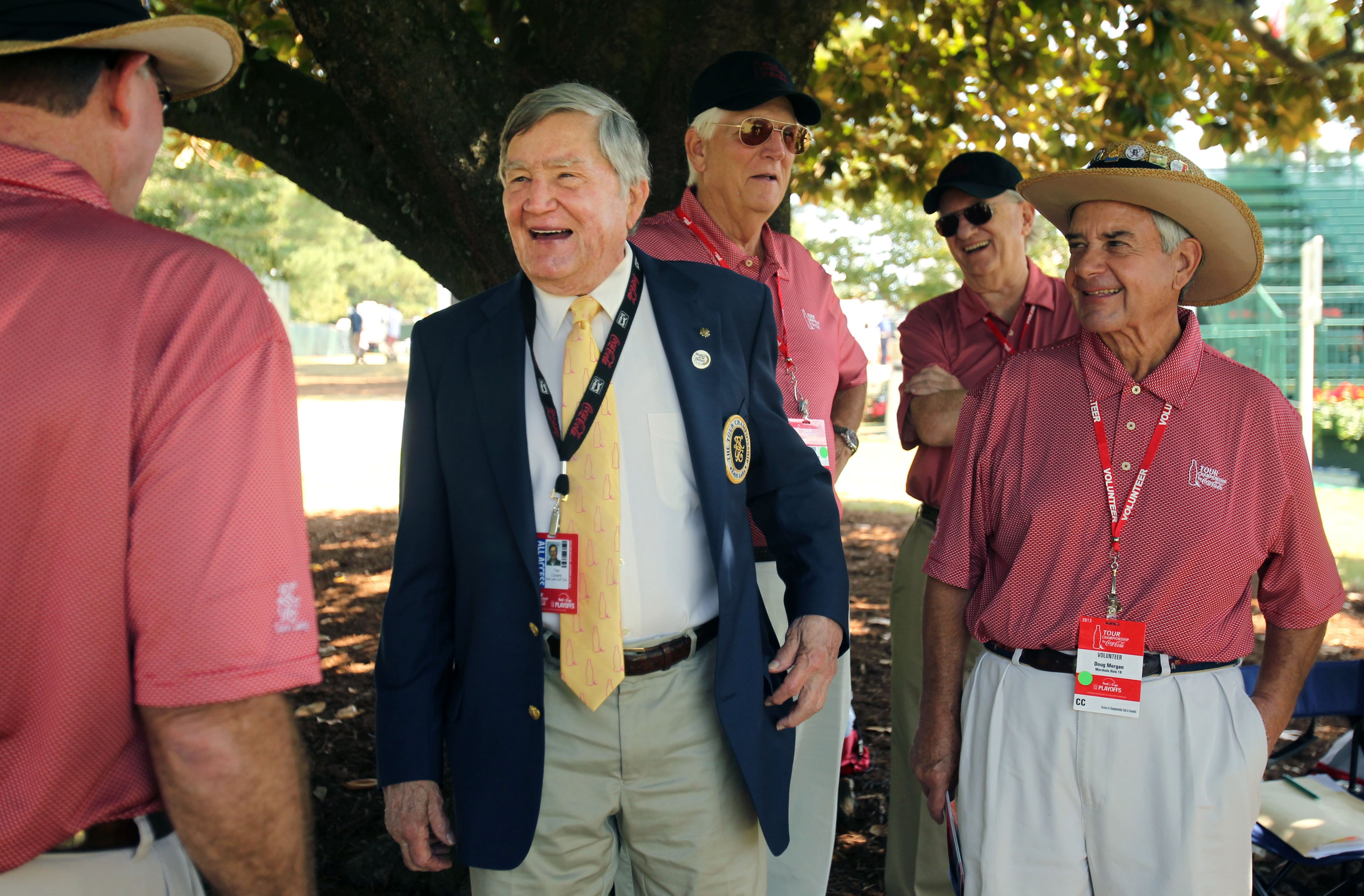 East Lake Foundation founder Tom Cousins (center) jokes with Hole No. 18 volunteers during round two of the 2013 Tour Championship at East Lake Golf Club. (AJC FILE)
