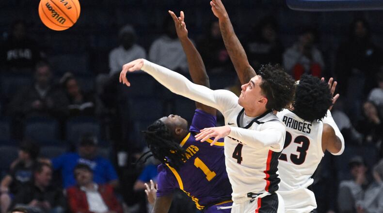 Georgia guard Jusaun Holt (4) rejects a shot by LSU guard Cam Hayes (1) as Braelen Bridges also defends in the first round of the SEC Tournament, Wednesday, March 8, 2023, in Nashville, Tenn. LSU won 72-67. (AP Photo/John Amis)