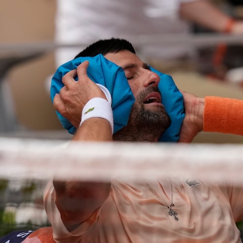 Novak Djokovic of Serbia cools himself during a break of the third round men's singles tennis match against Joao Fonseca of Brazil at the French Open tennis tournament in Paris, Friday, May 29, 2026. (AP Photo/Christophe Ena)