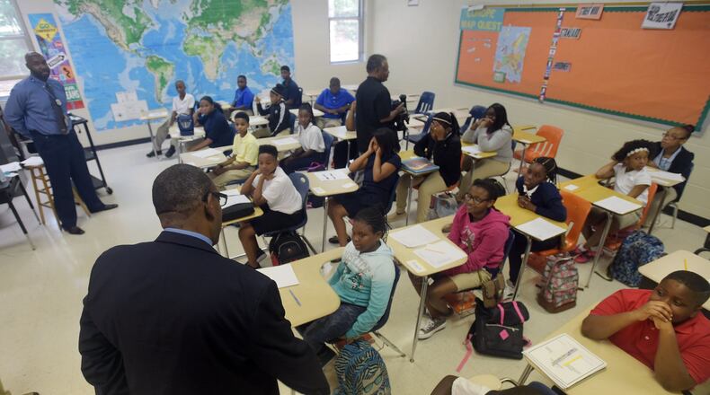 Superintendent Steve Green talks with sixth-grade students in teacher Paul Johnson’s social studies class in Chapel Hill Middle School on the first day of classes in August 2015. The district announced students will attend an extended school day through December to make up days lost to Tropical Storm Irma. KENT D. JOHNSON /KDJOHNSON@AJC.COM