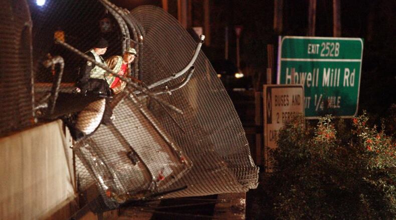 A charter bus carrying the Bluffton University baseball team crashed through the fence on the Northside Drive bridge over Interstate 75 on March 2, 2007. AJC file photo