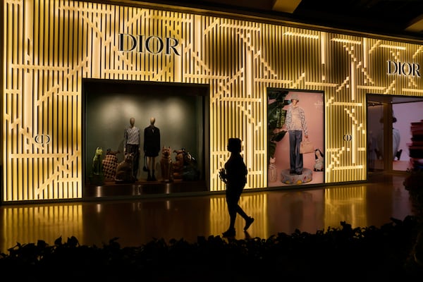 A person walks by a Dior store Tuesday, April 8, 2025, in Las Vegas. (AP Photo/John Locher)