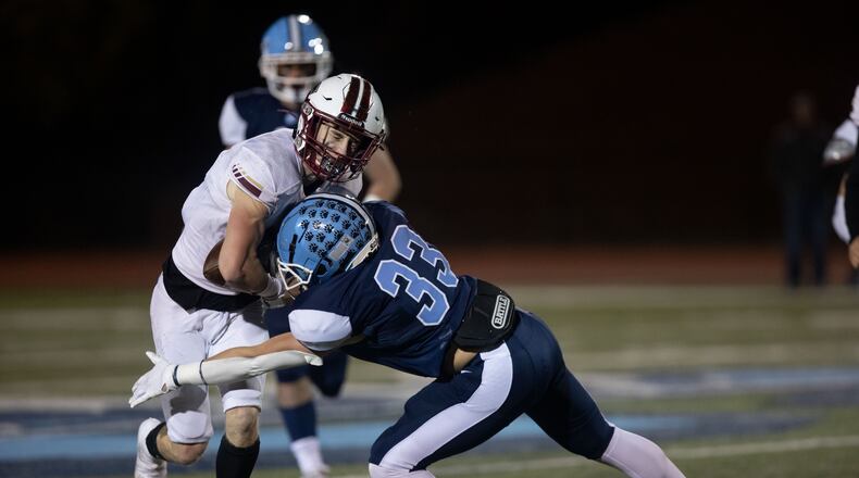 South Paulding's Alex Watkins (7) is tackled by Ben Ridenour (33) during a GHSA high school football game between Cambridge and South Paulding at Cambridge High School in Milton, GA., on Saturday, November 13, 2021. (Photo/Jenn Finch)