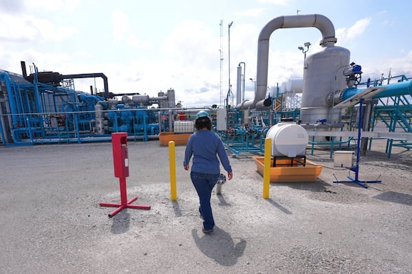 BKV Carbon Ventures senior facility engineer Laura Mamazza walks at a compression station at a carbon capture and sequestration facility in Bridgeport, Texas, Thursday, May 29, 2025. (AP Photo/LM Otero)