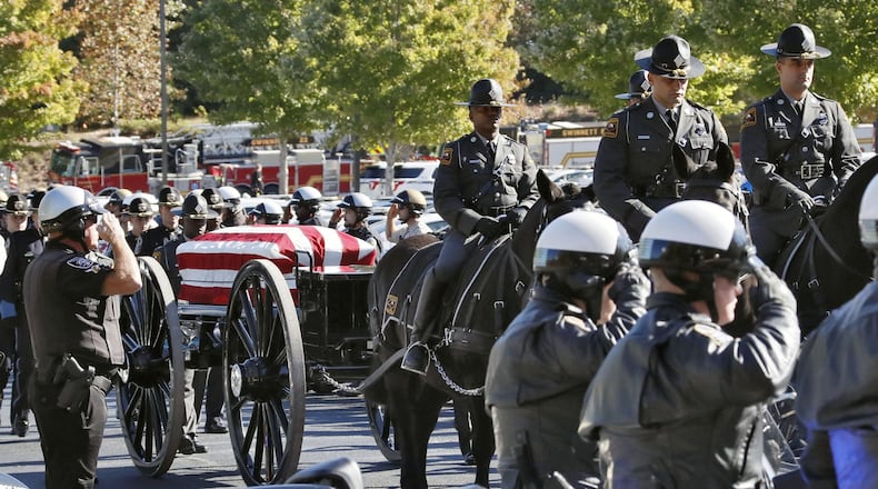 10/24/18 - Lawrenceville - A caisson carrying the casket processes through a motorcycle honor guard to the church. Funeral services were held for Gwinnett Police Officer Antwan Toney at 12Stone church in Lawrenceville. He was shot and killed last Saturday. BOB ANDRES / BANDRES@AJC.COM
