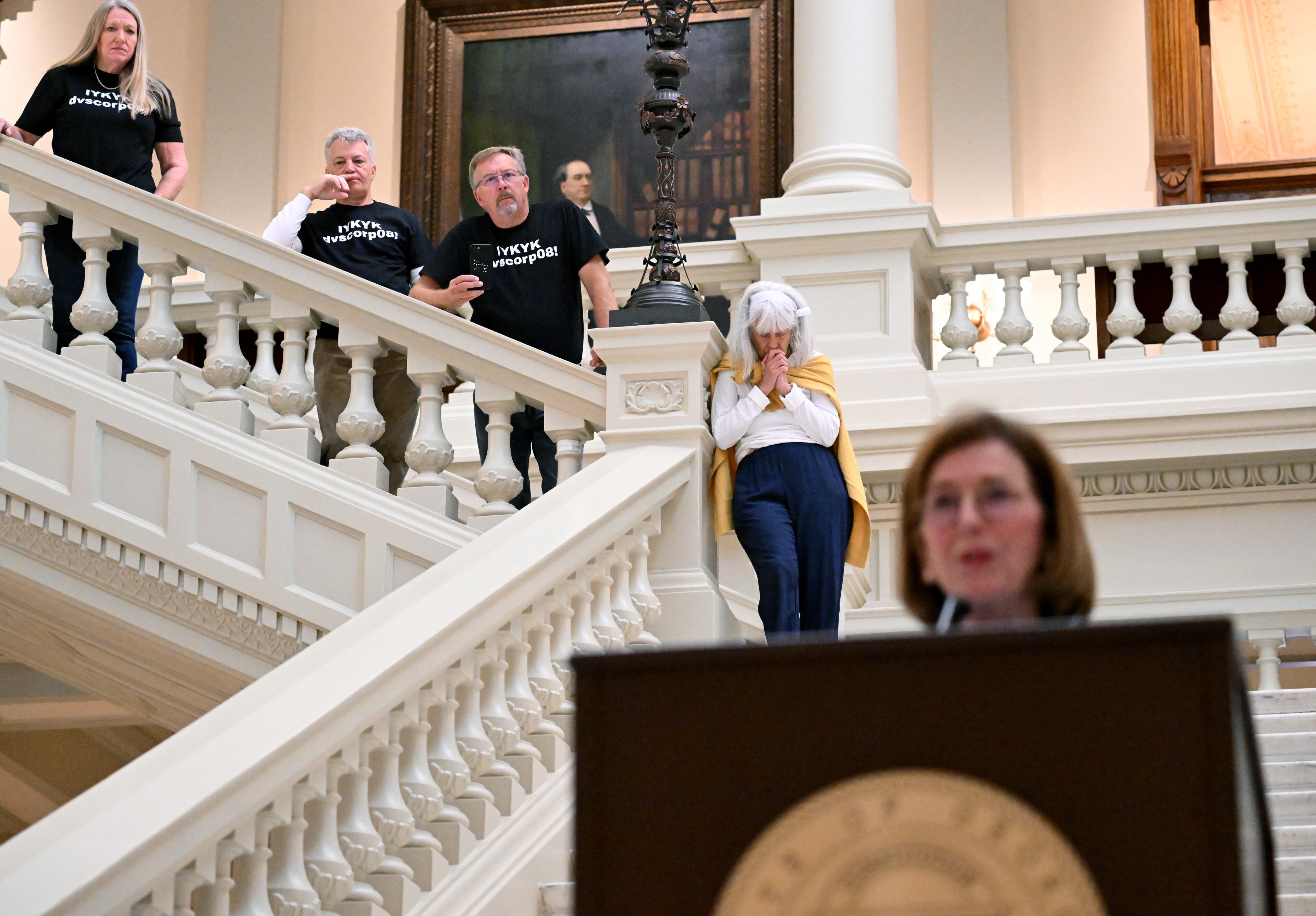 State Election Board member Janice Johnston speaks to members of the press as people (background) watch before the State Election Board’s final scheduled meeting of 2024 at the Georgia Capitol, Tuesday, Oct. 8, 2024, in Atlanta. (Hyosub Shin/AJC)