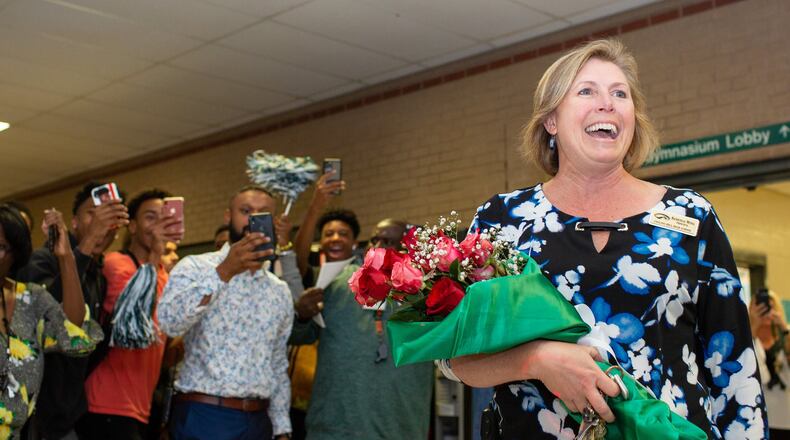 Collins Hill High School Principal Kerensa Wing walks into the lobby to a celebration by students and faculty on Monday, Oct. 21, 2019, in Suwanee. Wing was named 2020 National Principal of the Year by the National Association of Secondary School Principals. REBECCA WRIGHT FOR THE ATLANTA JOURNAL-CONSTITUTION