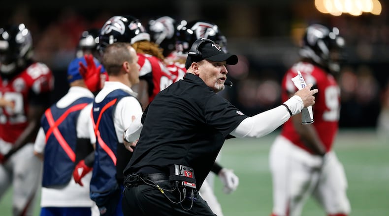 Atlanta Falcons head coach Dan Quinn speaks to players against the Green Bay Packers during the first of an NFL football game, Sunday, Sept. 17, 2017, in Atlanta. (AP Photo/John Bazemore)