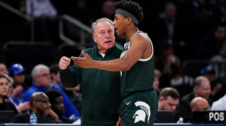 Michigan State head coach Tom Izzo, left, talks to Jeremy Fears Jr., right, during the first half of an NCAA college basketball game against Kentucky Tuesday, Nov. 18, 2025, in New York. (AP Photo/Frank Franklin II)