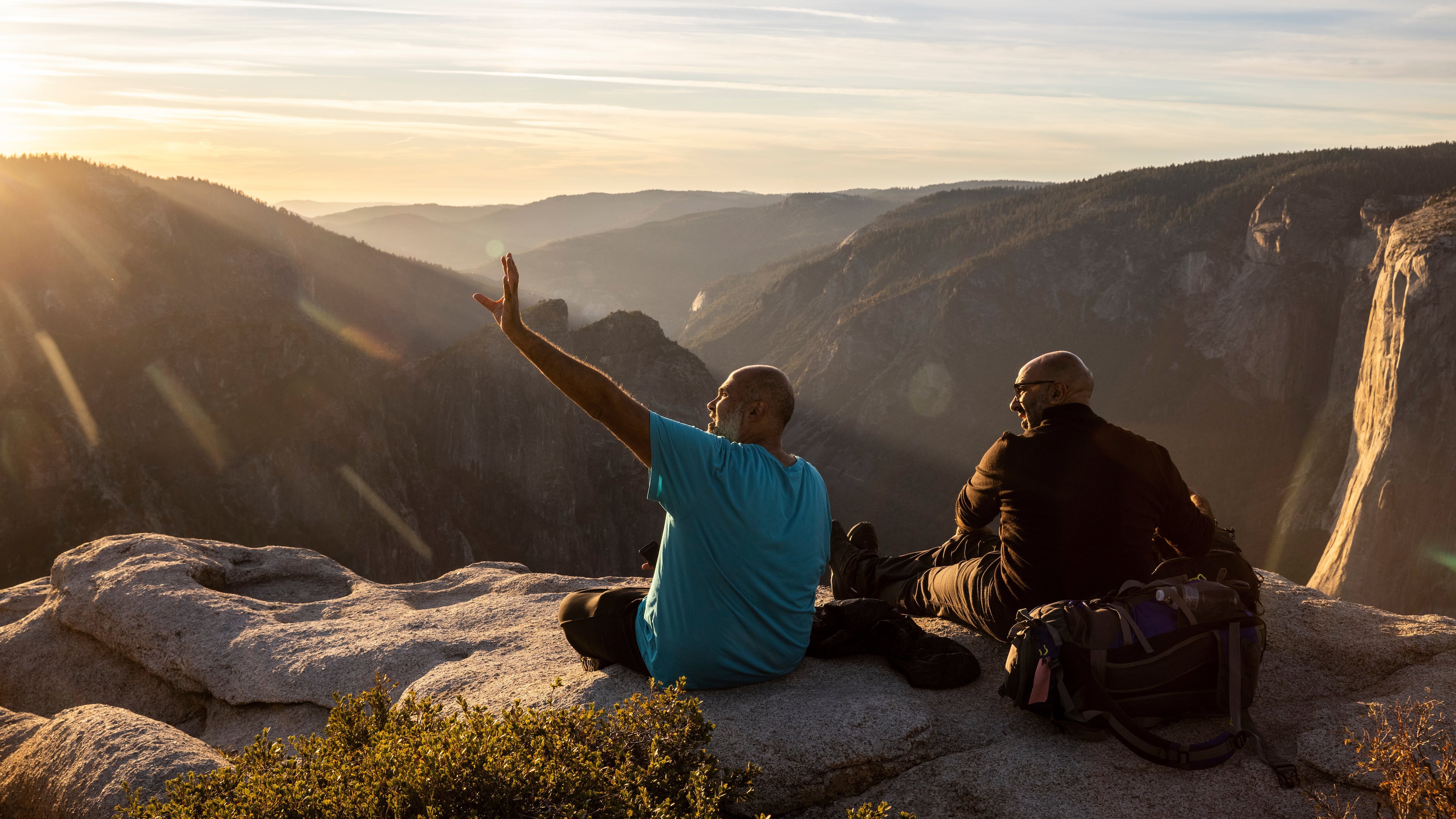 FILE - Visitors watch a sunset on rock ledge near Taft Point in Yosemite National Park, Calif., Oct. 30, 2025. (Stephen Lam/San Francisco Chronicle via AP, File)