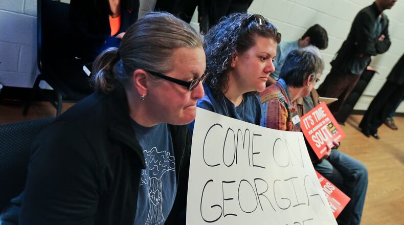 Partners, Tiffany White and Allsion White (right) hold a sign at the kick-off for the Freedom to Marry $1 million campaign to promote marriage equality across the South Monday, Feb. 24, 2014 at the Phillip Rush Center on DeKalb Avenue in Atlanta.