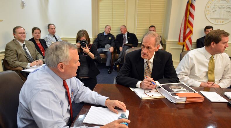 February 11, 2014. Atlanta: Gov. Nathan Deal talks with Georgia Emergency Management Director Charley English before the start a Emergency Operations Command committee meeting Tuesday February 11, 2014. BRANT SANDERLIN /BSANDERLIN@AJC.COM