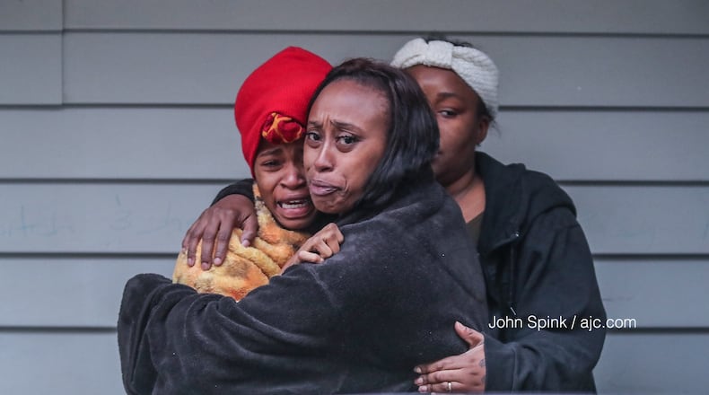 Guests at a Home Stay Suites on U.S. 78 in Gwinnett County console each other after a deadly shooting at the motel Wednesday morning.