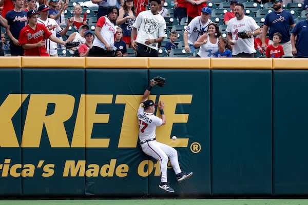 Braves outfielder Stuart Fairchild collides with the wall while failing to catch a fly ball against the Phillies on Sunday.