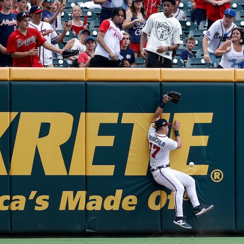 Atlanta Braves outfielder Stuart Fairchild collides with the wall as he tries to catch a deep ball hit by Philadelphia Phillies' Alec Bohm, Sunday, June 29, 2025, in Atlanta. (Butch Dill/AP)