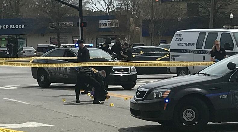 DeKalb County police check evidence after a deadly shooting.